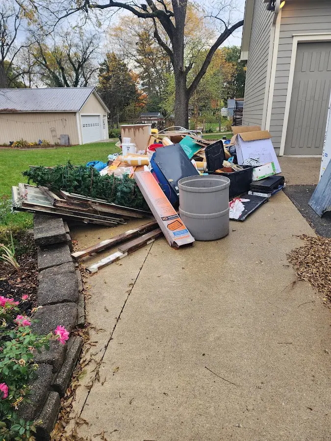 Dumpster being loaded with debris for Estate Cleanout Dumpster Rental in Mount Airy